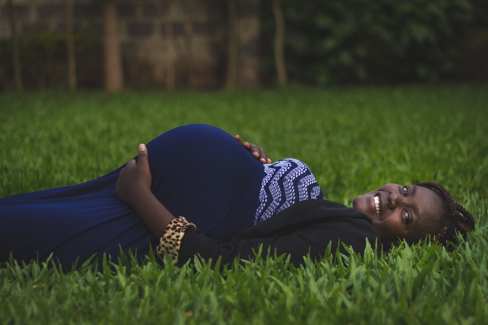 pregnant woman laying in a field