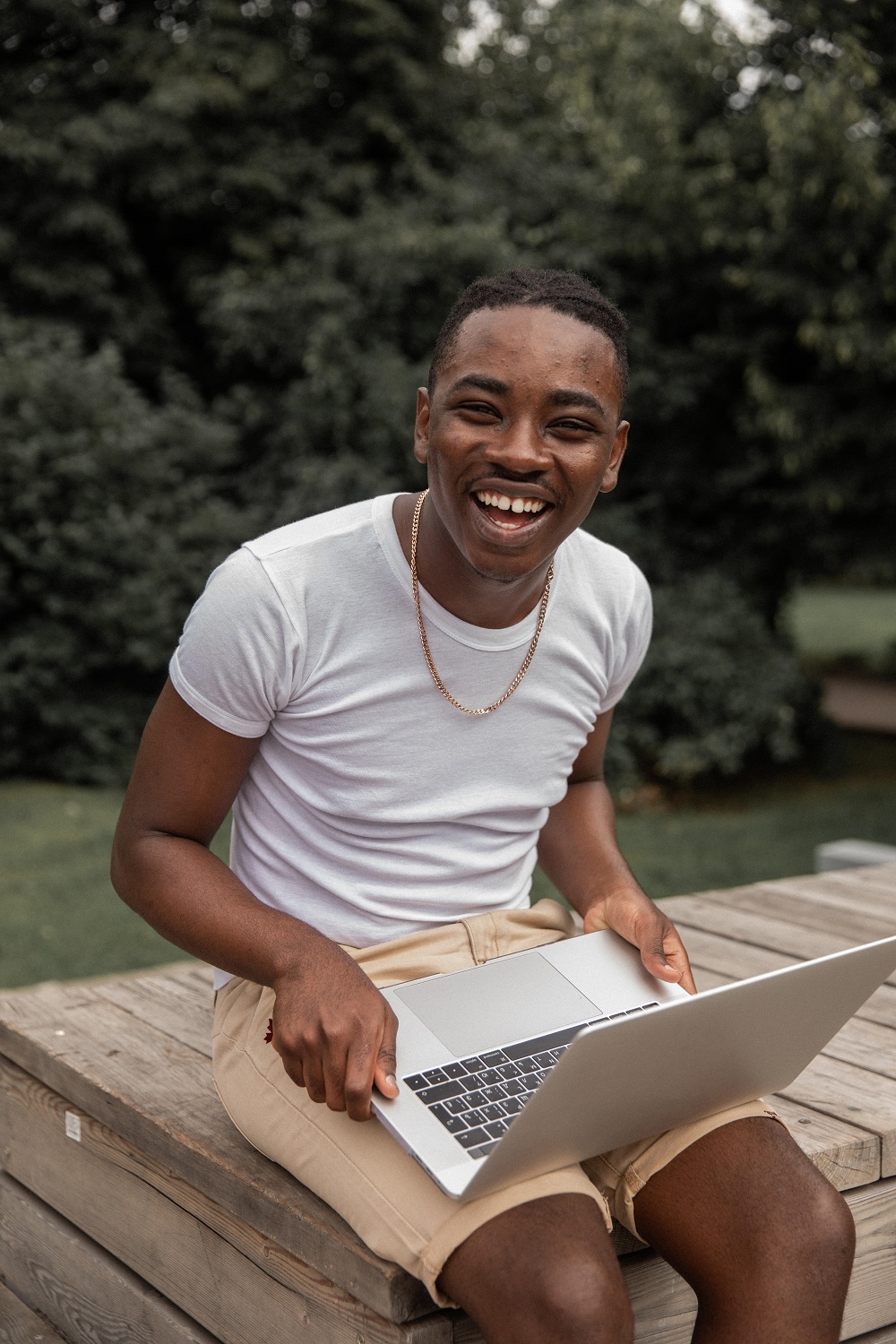 guy smiling with a laptop
